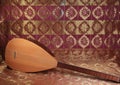 Traditional Turkish national musical instrument baglama saz on a dark red background. a magnificent century. The concept of Islam