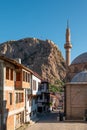 Traditional Turkish Ottoman houses in Afyonkarahisar Turkey. Afyon Castle on the rock and Mevlevihane Museum in front of it