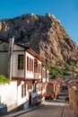 Traditional Turkish Ottoman houses in Afyonkarahisar Turkey. Afyon Castle on the rock and Mevlevihane Museum in front of it Royalty Free Stock Photo