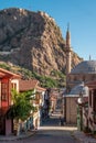 Traditional Turkish Ottoman houses in Afyonkarahisar Turkey. Afyon Castle on the rock and Mevlevihane Museum in front of it