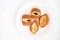 Traditional Turkish pastries - fresh buns with sesame seeds on a white plate on the breakfast table. Place for your text. Royalty Free Stock Photo