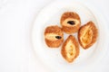 Traditional Turkish pastries - fresh buns with sesame seeds on a white plate on the breakfast table. Place for your text. Royalty Free Stock Photo