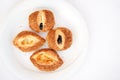 Traditional Turkish pastries - fresh buns with sesame seeds on a white plate on the breakfast table. Place for your text. Royalty Free Stock Photo