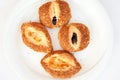 Traditional Turkish pastries - fresh curly buns with sesame seeds on a white plate on a breakfast table. Top view close up Royalty Free Stock Photo