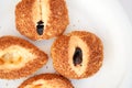 Traditional Turkish pastries - fresh curly buns with sesame seeds on a white plate on a breakfast table. Top view close up Royalty Free Stock Photo