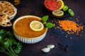 Traditional turkish lentil soup with lemon and mint in white bowl, lemon, tomato and pepper on the plate, flatbread, lentils, Royalty Free Stock Photo