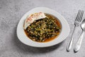 Traditional Turkish spinach meal with rice and minced meat with yogurt on a white porcelain plate Royalty Free Stock Photo