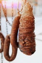 Traditional Turkish street food Kokoretsi and Sucuk meat sausage hanging on steel hook in outdoors