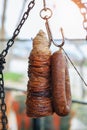 Traditional Turkish street food Kokoretsi and Sucuk meat sausage hanging on steel hook in outdoors