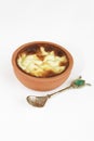 Traditional Turkish sweet supangle dish in a ceramic plate with a decor spoon on a white background