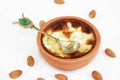 Traditional Turkish sweet supangle dish in a ceramic plate with a decor spoon on a white background