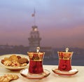 Traditional Turkish tea set of 2 tea glasses with Maiden Tower Istanbul silhouette background. Royalty Free Stock Photo