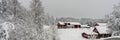 Traditional typical Scandinavian Swedish red cottages or villas in the countryside in winter. Old wooden houses under snow. Winter Royalty Free Stock Photo