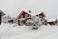 Traditional typical Scandinavian Swedish red house or villa in the countryside in winter. Old wooden house under snow. Winter Royalty Free Stock Photo