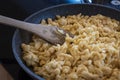 traditional tyrolean house dish kaesspatzn in a pan with a wooden spatula