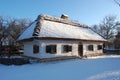 Traditional Ukrainian architecture. Old house with thatched roof and wooden church. Pirogovo museum, Kiev, Ukraine, Europe