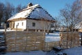 Traditional Ukrainian architecture. Old house with thatched roof and wooden church. Pirogovo museum, Kiev, Ukraine, Europe