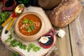 Traditional Ukrainian beet soup borscht in wooden bowl with garlic buns pampushka and dry cured pork belly on rustic wooden table Royalty Free Stock Photo