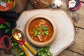 Traditional Ukrainian beet soup borscht in wooden bowl with garlic buns pampushka and dry cured pork belly on rustic wooden table Royalty Free Stock Photo