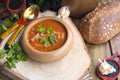 Traditional Ukrainian beet soup borscht in wooden bowl with garlic buns pampushka and dry cured pork belly on rustic wooden table. Royalty Free Stock Photo