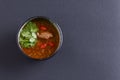 Traditional Ukrainian beetroot soup - borscht or borshch with meat and fresh parsley over black background. Copy space. Royalty Free Stock Photo