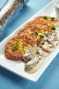 Traditional Ukrainian and Belarusian dish - fried potato pancakes draniki, deruny with sour cream and porcini mushrooms, served Royalty Free Stock Photo