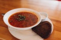Traditional Ukrainian borsch. White Bowl of red beet root soup and greens. Sour delicious soup with potato Royalty Free Stock Photo