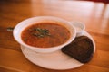 Traditional Ukrainian borsch. White Bowl of red beet root soup and greens. Sour delicious soup with potato Royalty Free Stock Photo