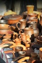 Traditional ukrainian cooking stove clay pots, mugs and jugs on market stall. Vintage pottery Royalty Free Stock Photo