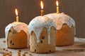 Traditional ukrainian culture easter cake called kulich sweet bread with three burning candles and icing on rustic textile