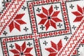 Traditional Ukrainian embroidery on white canvas as background, closeup. National handicraft