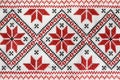 Traditional Ukrainian embroidery on white canvas as background, closeup. National handicraft