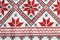 Traditional Ukrainian embroidery on white canvas as background, closeup. National handicraft