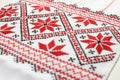 Traditional Ukrainian embroidery on white canvas, closeup. National handicraft