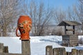 Traditional Ukrainian rural landscape with a wooden well and fence with hanging pitcher on it with Petrykivka folk painting