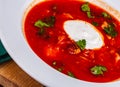 Traditional Ukrainian Russian borscht or beetroot red soup with sour cream in white plate Royalty Free Stock Photo