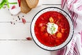 Traditional Ukrainian Russian borscht with white beans on the bowl.