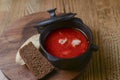 Traditional Ukrainian Russian soup, Borscht. Beetroot soup in bowl on wooden board and rustic wooden background Royalty Free Stock Photo