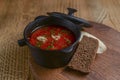 Traditional Ukrainian Russian soup, Borscht. Beetroot soup in bowl on wooden board and rustic wooden background Royalty Free Stock Photo