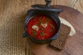 Traditional Ukrainian Russian soup, Borscht. Beetroot soup in bowl on wooden board and rustic wooden background Royalty Free Stock Photo