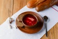 Traditional Ukrainian Russian soup, Borscht. Beetroot soup in bowl on wooden board and rustic wooden background Royalty Free Stock Photo