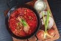 Traditional Ukrainian Russian vegetable borscht. Ukrainian beetroot soup in a bowl with meet, greenery and garlic bread Royalty Free Stock Photo