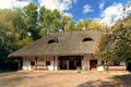 Traditional ukrainian village old-style house with thatched roof on background of blue sky in autumn. Copy space Royalty Free Stock Photo