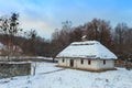 Traditional Ukrainian village in winter. Old house at Pirogovo ethnographic museum, Royalty Free Stock Photo