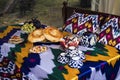 Traditional Uzbek bread on table with mugs and kettle. Cuisine of Central Asia. fruits grapes and pomegranate and sweets in plates Royalty Free Stock Photo