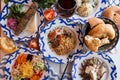 Traditional Uzbek dinner. Pilaf, manta, kebab, bread on the table with vegetables