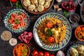 Traditional Uzbek oriental cuisine. Uzbek family table from different dishes in national dishes for the New Year holiday