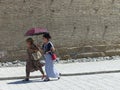 Traditional Uzbek women with an umbrella under the sun to Bukhara in Uzbekistan.