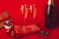 Traditional Valentines day background. Red seasonal romantic dinner with gift, postcard, champagne and chocolate candies