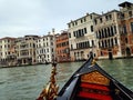 Traditional Venetian gondola gliding along a picturesque canal in the historic city of Venice, Italy Royalty Free Stock Photo